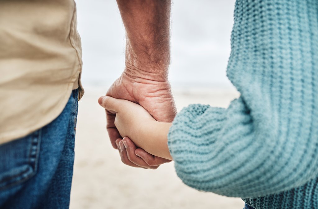 Intergenerational contract | unisg.ch family, beach and father holding hands with kid in support, child care trust and love while enjoy peace, freedom or bond. Quality time, travel and young youth girl and dad relax together on calm sand